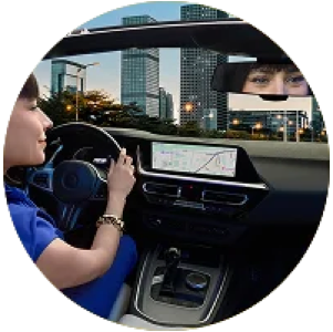 Woman in bed using her phone in low light, representing everyday visual comfort needs